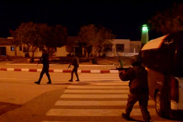  Members of the security forces stand near the entrance of Ghriba synagogue, following an attack, in Djerba, Tunisia May 9, 2023, in this screen grab from a video.  (photo credit: STRINGER/ REUTERS)