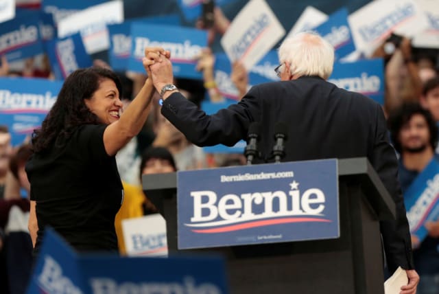  US Rep Rashida Tlaib and Democratic 2020 US presidential candidate Senator Bernie Sanders exit the stage following a campaign rally for Sanders in Detroit, Michigan, US October 27, 2019 (photo credit: REUTERS/REBECCA COOK)