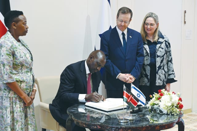  PRESIDENT WILLIAM RUTO of Kenya signs the guest book at the President’s Residence while his wife, Rachel, and President Isaac Herzog and his wife, Michal, look on.  (photo credit: HAIM ZACH/GPO)