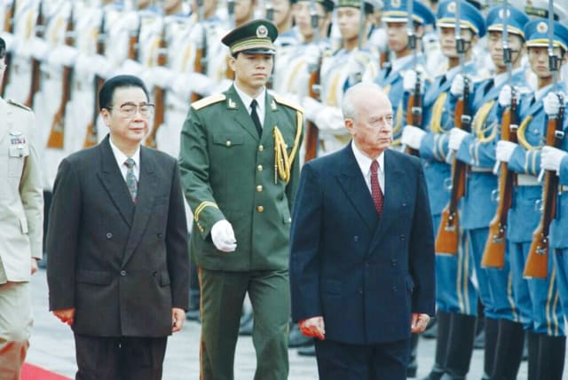  THEN-PRIME MINISTER Yitzhak Rabin reviews an honor guard during his state visit to China in 1993, as then-Chinese prime minister Li Peng walks alongside him. (photo credit: YAACOV SAAR/GPO)
