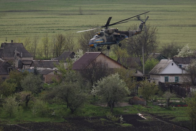 Ukrainian military helicopter flies over a village, amid Russia's attack on Ukraine, in Donetsk region, Ukraine April 29, 2023 (photo credit: Sofiia Gatilova/Reuters)