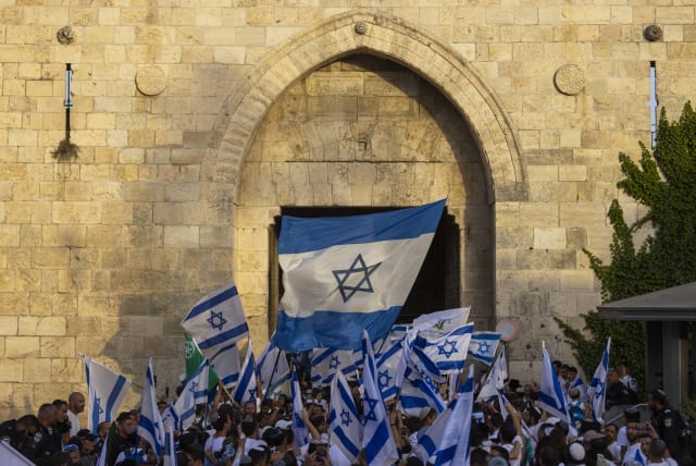  Young Jewish men holding Israeli flags as they dance at Damascus Gate in Jerusalem's Old City, during Jerusalem Day celebrations, May 29, 2022. (photo credit: OLIVIER FITOUSSI/FLASH90)