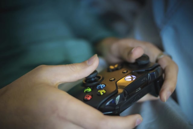  Illustrative image of a person playing with an Xbox console. (photo credit: RAWPIXEL)