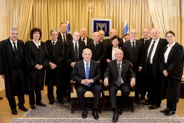  Then-president Reuven Rivlin and Prime Minister Benjamin Netanyahu pose for a group photo with Supreme Court justices in 2015. (photo credit: KOBI GIDEON/GPO)