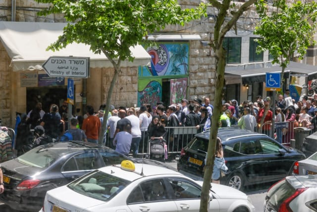 People queue outside Jerusalem Interior Ministry office for passport renewals. May 2023. (photo credit: MARC ISRAEL SELLEM)