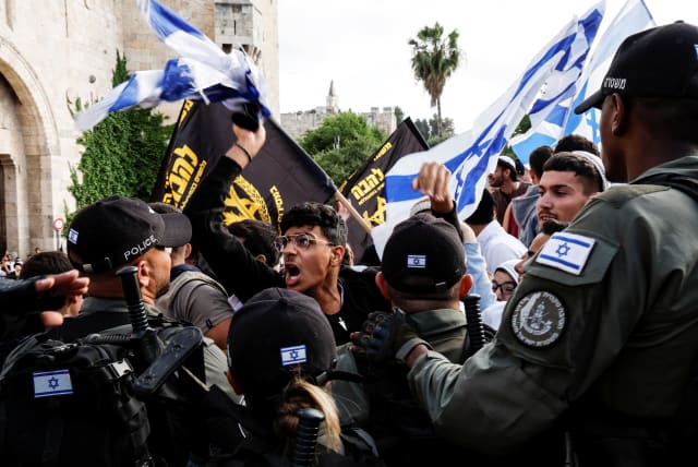  Israeli security personnel stand by as Israelis shout slogans and gather at Damascus gate to Jerusalem's Old city marking Jerusalem Day, in Jerusalem May 18, 2023 (photo credit: AMMAR AWAD/REUTERS)