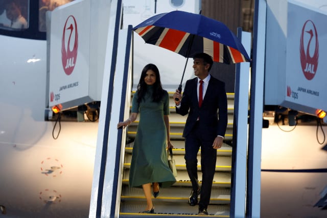 British Prime Minister Rishi Sunak accompanied by his wife Akshata Murty, arrives at Hiroshima airport, ahead of the G7 leaders' summit in Mihara, Hiroshima, Japan May 18, 2023.  (photo credit: REUTERS/Androniki Christodoulou)