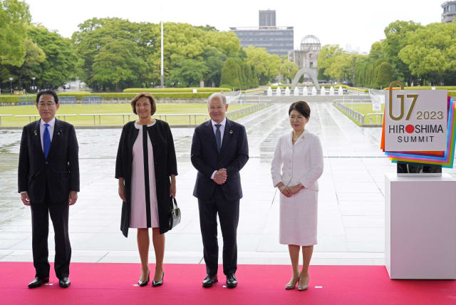 German Chancellor Olaf Scholz and his wife Britta Ernst pose for a photo with Japan’s Prime Minister Fumio Kishida and his wife Yuko Kishida at the Peace Memorial Park during a visit as part of the G7 Hiroshima Summit in Hiroshima, Japan, 19 May 2023. The G7 Hiroshima Summit will be held from 19 to  (photo credit: FRANCK ROBICHON POOL/Pool via REUTERS)