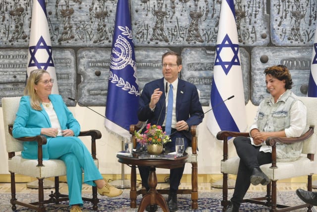  PRESIDENT ISAAC Herzog, flanked by his wife, Michal, and Hila Pe’er.  (photo credit: AMOS BEN GERSHOM/GPO)