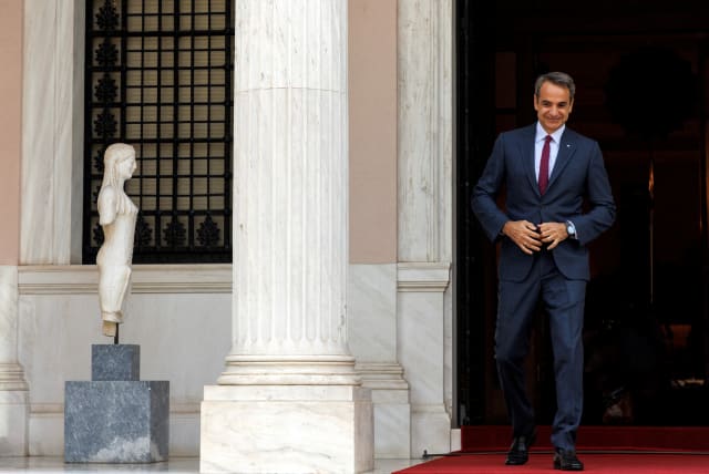 Greek Prime Minister Kyriakos Mitsotakis arrives to welcome his Romanian counterpart Nicolae Ciuca (not pictured), at the Maximos Mansion in Athens, Greece, July 7, 2022. (photo credit: ALKIS KONSTANTINIDIS / REUTERS)