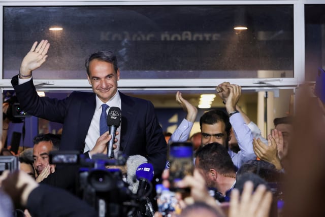  Greek Prime Minister and New Democracy conservative party leader Kyriakos Mitsotakis waves outside the party's headquarters, after the general election, in Athens, Greece, May 21, 2023. (photo credit: Louiza Vradi/Reuters)