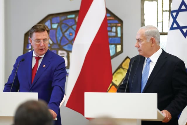  PRIME MINISTER Benjamin Netanyahu holds a news conference with then-Latvian prime minister Maris Kucinskis, in 2018.  (photo credit: Ints Kalnins/Reuters)