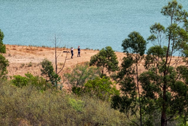  Officers of Portugal's investigative Judicial Police are seen at the site of a remote reservoir where a new search for the body of Madeleine McCann is set to take place, in Silves, Portugal, in this screen grab from a video, May 22, 2023 (photo credit: REUTERS)