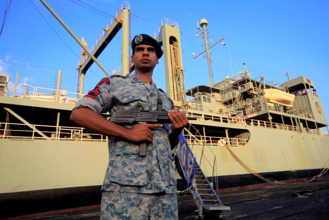  An Iranian soldier stands guard near Iranian Navy helicopter carrier Kharg at Port Sudan at the Red Sea State, October 31, 2012. (photo credit: MOHAMED NURELDIN ABDALLAH/REUTERS)