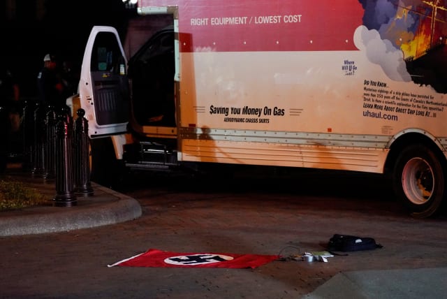  A Nazi flag and other objects recovered from a rented box truck are pictured on the ground as the U.S. Secret Service and other law enforcement agencies investigate the truck that crashed into security barriers at Lafayette Park across from the White House in Washington, U.S. May 23, 2023. (photo credit: REUTERS)