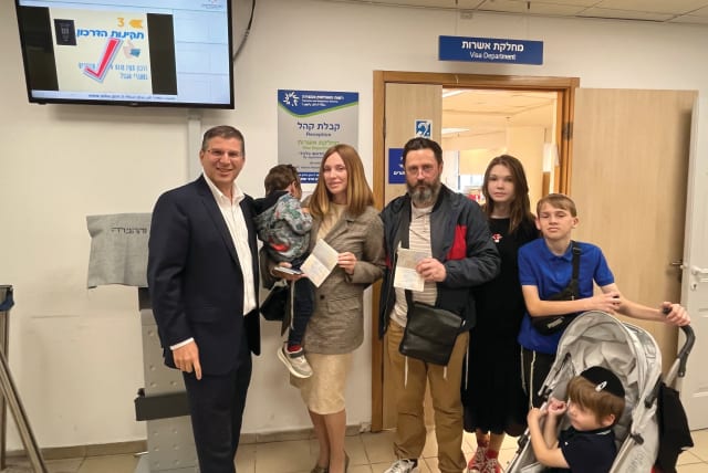  THE AGPOV family with ITIM head Rabbi Seth Farber (L) after receiving Israeli citizenship at the Netanya Interior Ministry offices. (photo credit: COURTESY ITIM)