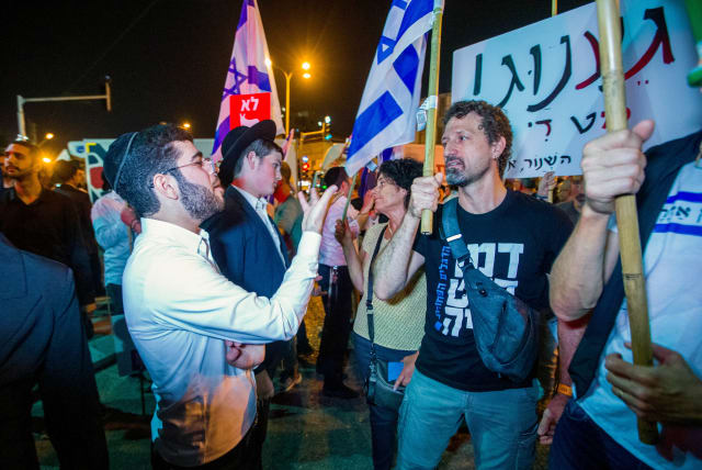  Demonstrators argue with Ultra orthodox jews during a protest march in Bnei Brak, against the billions in funds provided to ultra-Orthodox parties in the state budget, on May 17, 2023.  (photo credit: FLASH90)
