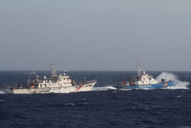 A ship (R) of Vietnam Marine Guard is seen near a ship of Chinese Coast Guard in the South China Sea, about 210 km (130 miles) off shore of Vietnam May 14, 2014. (photo credit: REUTERS/Nguyen Minh/File)