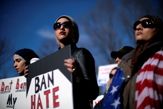  Activist groups including the Council on American-Islamic Relations, MoveOn.org, Oxfam, and the ACLU hold a rally in front of the White House to mark the anniversary of the first Trump administration travel and refugee ban in Washington, US, January 27, 2018. (photo credit: REUTERS/JAMES LAWLER DUGGAN)