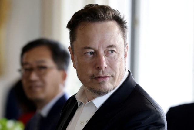  SpaceX, Twitter and Tesla CEO Elon Musk looks on as he attends a roundtable during the 6th edition of the "Choose France" Summit at the Chateau de Versailles, outside Paris, France on May 15, 2023. (photo credit: Ludovic Marin/Pool via REUTERS/File Photo)