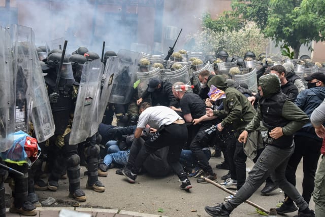  NATO Kosovo Force (KFOR) soldiers clash with local Kosovo Serb protesters at the entrance of the municipality office, in the town of Zvecan, Kosovo, May 29, 2023 (photo credit: REUTERS/LAURA HASANI)