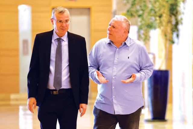  JUSTICE MINISTER Yariv Levin and his Likud colleague David Amsalem, minister at the Justice Ministry and regional cooperation minister, talk while they walk in the Knesset this week (photo credit: MARC ISRAEL SELLEM/THE JERUSALEM POST)