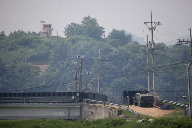 A South Korean soldier in an armoured vehicle stands guard as a North Korean guard post is seen in this picture taken near the demilitarized zone which separates the two Koreas in Paju, South Korea, May 31, 2023. (photo credit: KIM HONG-JI/ REUTERS)