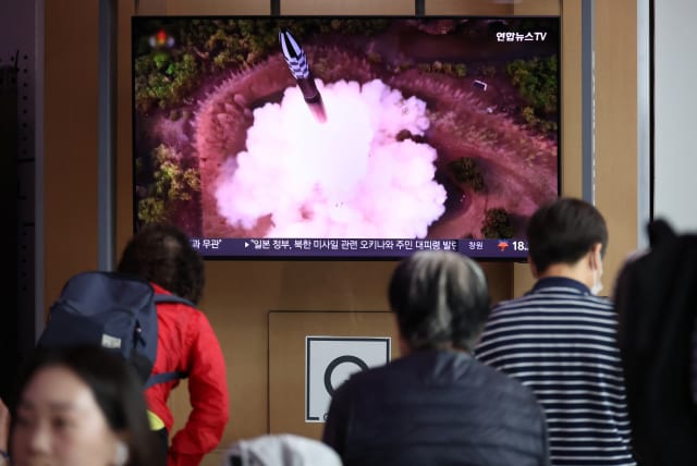 People watch a TV broadcasting a news report on North Korea firing what it called a space satellite toward the south, in Seoul, South Korea, May 31, 2023. (photo credit: KIM HONG-JI/ REUTERS)