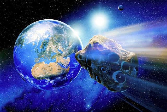  An asteroid is seen flying near Earth in this artistic illustration. (photo credit: PIXABAY)