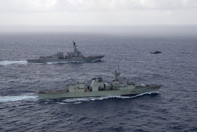  U.S. Navy guided-missile destroyer USS Chung-Hoon sails alongside the Royal Canadian Navy frigate HMCS Montreal during Surface Action Group operations as a part of exercise “Noble Wolverine" in the South China Sea May 30, 2023. (photo credit:  US Navy/Naval Air Crewman (Helicopter) 1st Class Dalton Cooper/Handout via REUTERS)