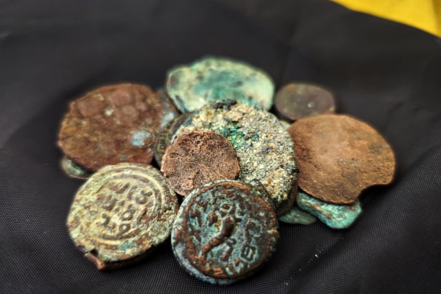  Ancient coins, including one from the reign of the last Jewish king, Antigonus II Mattathias, are seen after having been recovered from an alleged thief in eastern Jerusalem. (photo credit: Israel Antiquities Authority)