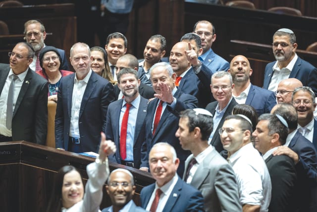  PRIME MINISTER Benjamin Netanyahu, cabinet ministers and coalitin MKs celebrate the passage of the state budget in the Knesset plenum, last month. (photo credit: YONATAN SINDEL/FLASH90)