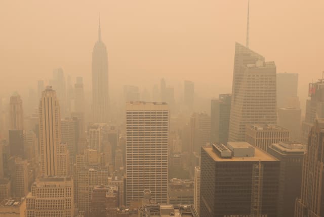  A view from the top of the Rockefeller Center, as haze and smoke caused by wildfires in Canada hang over the Manhattan skyline, in New York City, New York, US, June 7, 2023.  (photo credit: Andrew Kelly/Reuters)