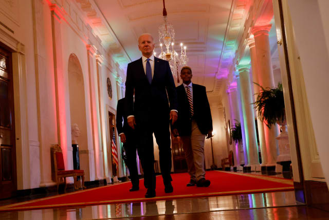  U.S. President Joe Biden and LGBTQ advocate Ashton Mota of the GenderCool Project walk before delivering remarks to commemorate LGBTQ+ Pride Month in the White House, Washington, U.S., June 25, 2021. (photo credit: REUTERS/JONATHAN ERNST)