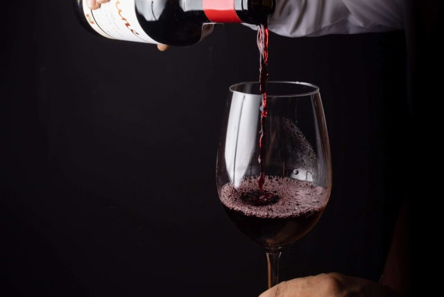  Person pouring wine into a glass (photo credit: PEXELS)