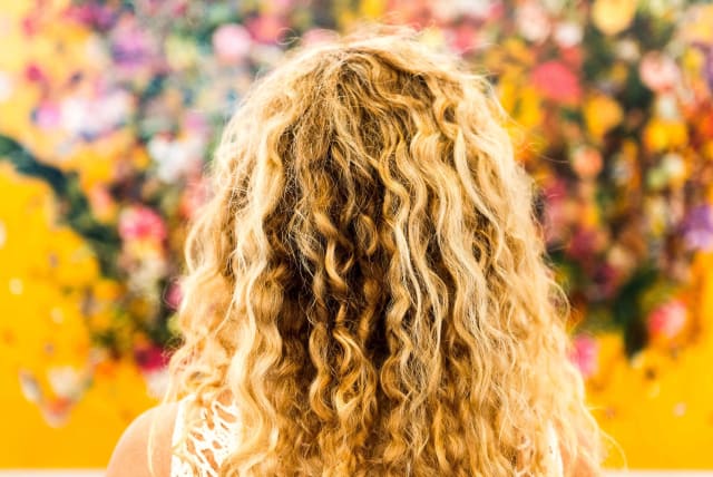  Illustrative image of a woman with curly blond hair. (photo credit: WALLPAPER FLARE)