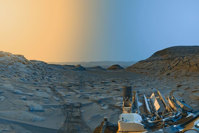 NASA’s Curiosity Mars rover used its black-and-white navigation cameras to capture panoramas of “Marker Band Valley” at two times of day on April 8. Color was added to a combination of both panoramas for an artistic interpretation of the scene. (photo credit: NASA/JPL-Caltech)