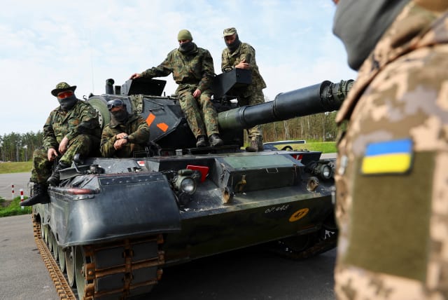 Ukrainian soldiers are pictured on a Leopard 1A5 tank, at the German army Bundeswehr base, part of the EU Military Assistance Mission in support of Ukraine (EUMAM Ukraine) in Klietz, Germany, May 5, 2023 (photo credit: REUTERS/FABRIZIO BENSCH)