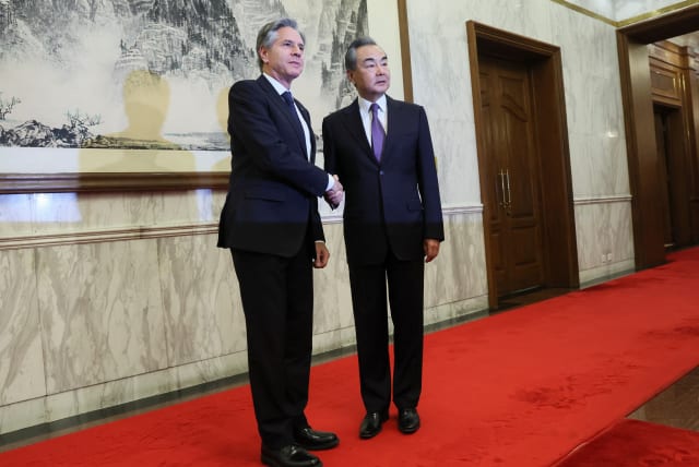 U.S. Secretary of State Antony Blinken shakes hands with China's Director of the Office of the Central Foreign Affairs Commission Wang Yi at the Diaoyutai State Guesthouse in Beijing, China, June 19, 2023. (photo credit: REUTERS/LEAH MILLIS/POOL)