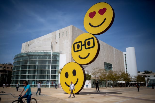 "Smiley"'s posted on a sculpture on ha Bima square in Tel Aviv. March 19, 2016. (photo credit: MIRIAM ALSTER/FLASH90)
