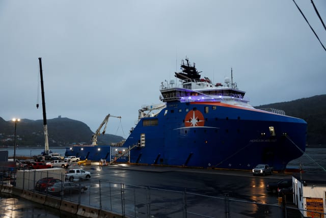 Equipment that was flown in by US Air Force transport planes is loaded onto the offshore vessel Horizon Arctic, before its deployment to the search area of a missing OceanGate Expeditions submersible in the port of St. John’s, Newfoundland, Canada June 20, 2023 (photo credit: REUTERS/DAVID HISCOCK)