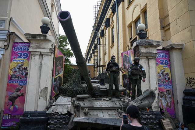Fighters of Wagner private mercenary group stand on a tank outside a local circus near the headquarters of the Southern Military District in the city of Rostov-on-Don, Russia, June 24, 2023 (photo credit:  REUTERS/Stringer)