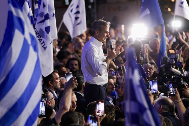  Former Greek Prime Minister and New Democracy conservative party leader Kyriakos Mitsotakis speaks to supporters outside the party's headquarters, after the general election, in Athens, Greece, June 25, 2023. (photo credit: REUTERS/LOUIZA VRADI)