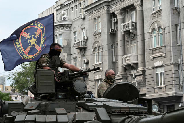  Fighters of Wagner private mercenary group are seen atop a tank while being deployed near the headquarters of the Southern Military District in the city of Rostov-on-Don, Russia, June 24, 2023 (photo credit: REUTERS/STRINGER/FILE PHOTO)