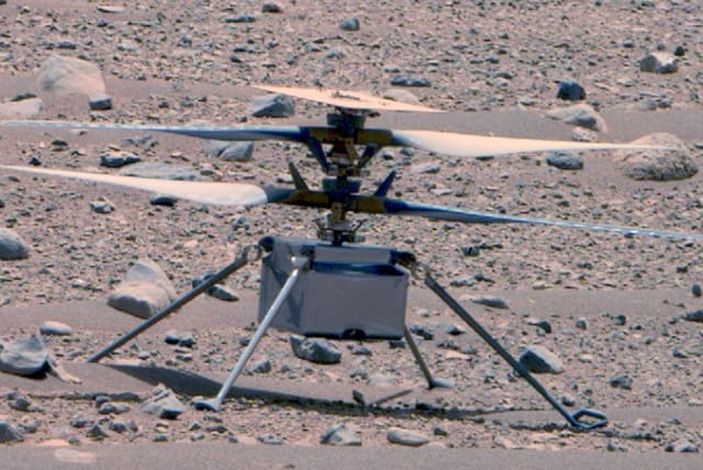  NASA’s Ingenuity Mars Helicopter was captured by the Perseverance rover’s Mastcam-Z on April 16, not long after the rotorcraft’s 50th flight. The helicopter would soon fall silent for 63 days due hilly terrain that interrupted communications between the rover and aircraft. (photo credit: NASA/JPL-Caltech/ASU/MSSS)