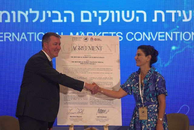  (L-R) Massimo Manetti and Tali Friedman sign the Matching Markets Deal between Florence's historic market and Machane Yehuda, July 3, 2023 in Jerusalem. (photo credit: DARIO SANCHEZ/THE MEDIA LINE)