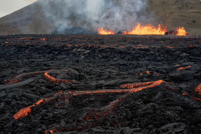  Iceland's Fagradalsfjall volcano sputters lava from the uninhabited Meradalir Valley on the Reykjanes peninsula, about 20 miles from Reykjavik, Iceland August 5, 2022.  (photo credit: REUTERS/KEN CEDENO/FILE PHOTO)