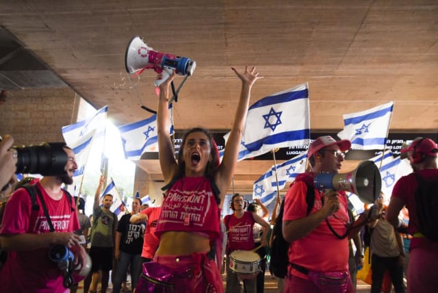  Demonstrators holding up signs and protesting at Ben Gurion Airport (photo credit: I.H. Mintz)