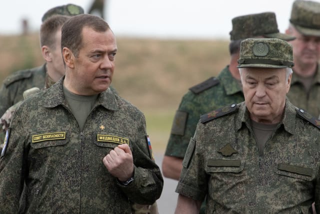  Russia's Deputy head of the Security Council Dmitry Medvedev, accompanied by Deputy Defence Minister Nikolay Pankov, visits the Prudboi military training ground in Volgograd region, Russia June 1, 2023.  (photo credit: SPUTNIK/YEKATERINA SHTUKINA/POOL VIA REUTERS)
