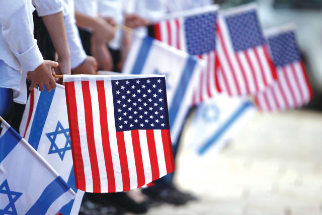  JERUSALEM SCHOOLCHILDREN hold Israeli and American flags during a rehearsal for former US President Barack Obama’s visit to Israel in 2013. (photo credit: BAZ RATNER/REUTERS)